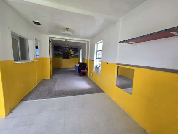 a view of a living room with furniture and a large window