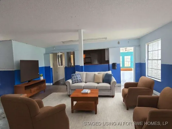 a living room with furniture a couch and a flat screen tv