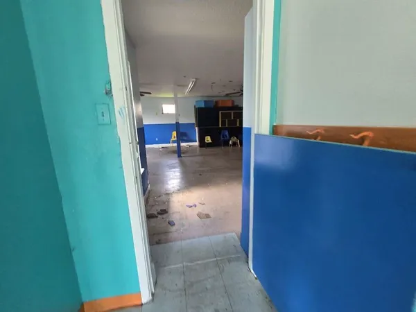 a view of a livingroom with an empty space and a window