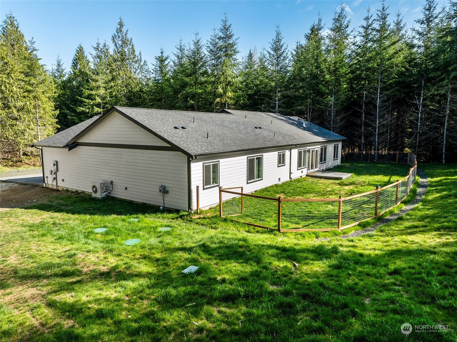 471 Southeast Ellis Road Shelton, WA 98584 - Photo 33 of 38 a house that is sitting in the grass with large trees