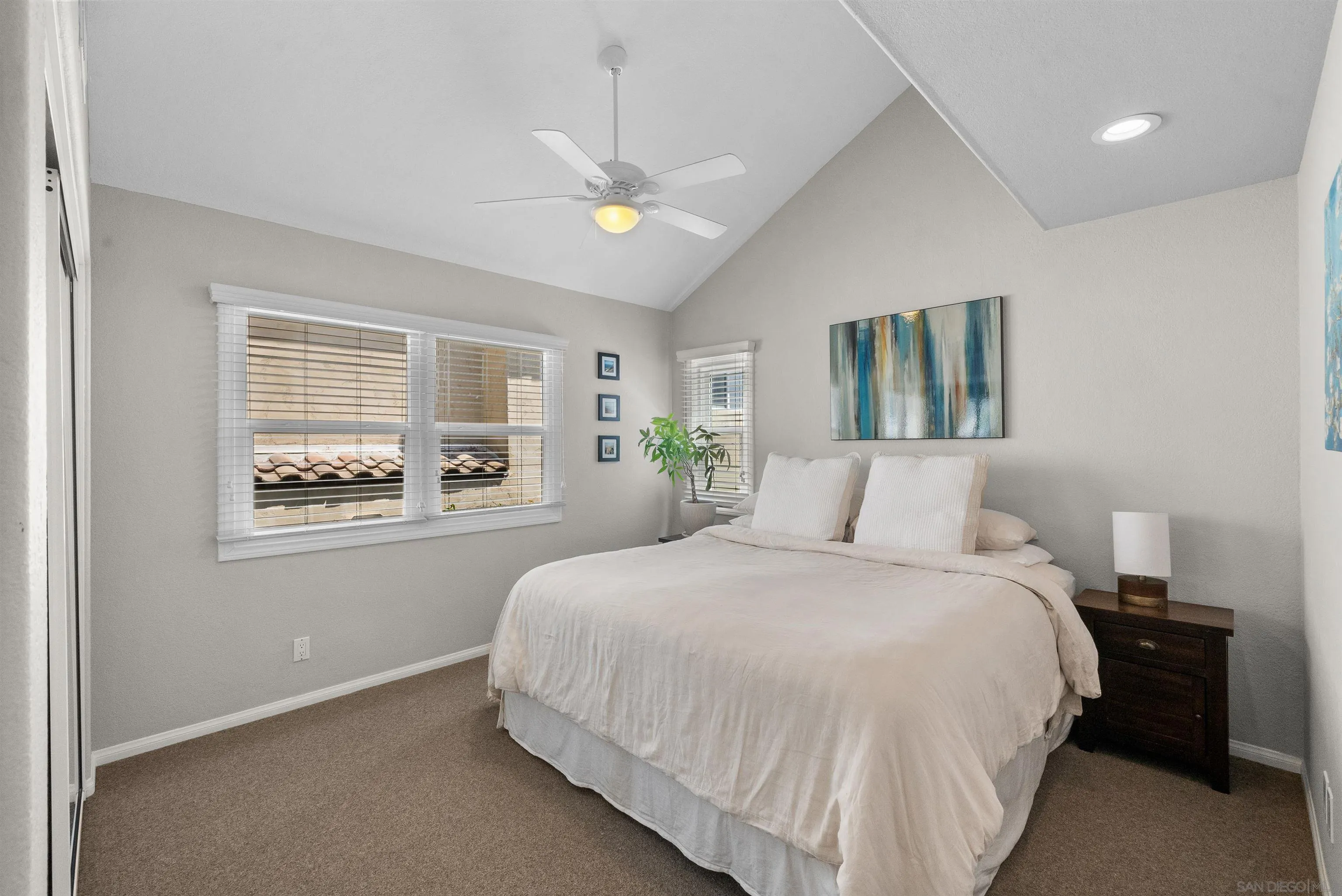 6755 Tyrian Street La Jolla, CA 92037 - Photo 20 of 60 a bedroom with a large bed and a window