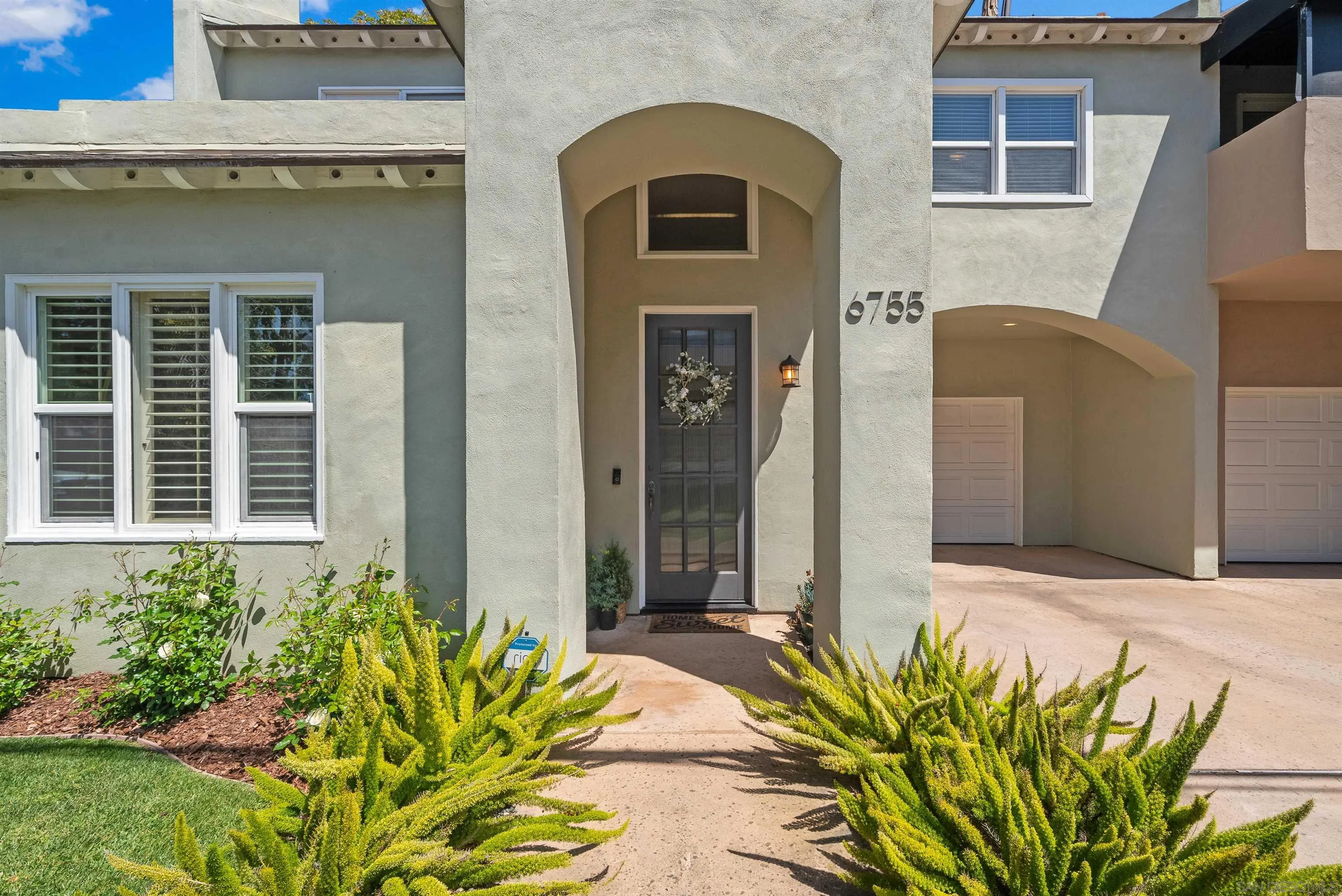 6755 Tyrian Street La Jolla, CA 92037 - Photo 2 of 60 a front view of a house with a yard