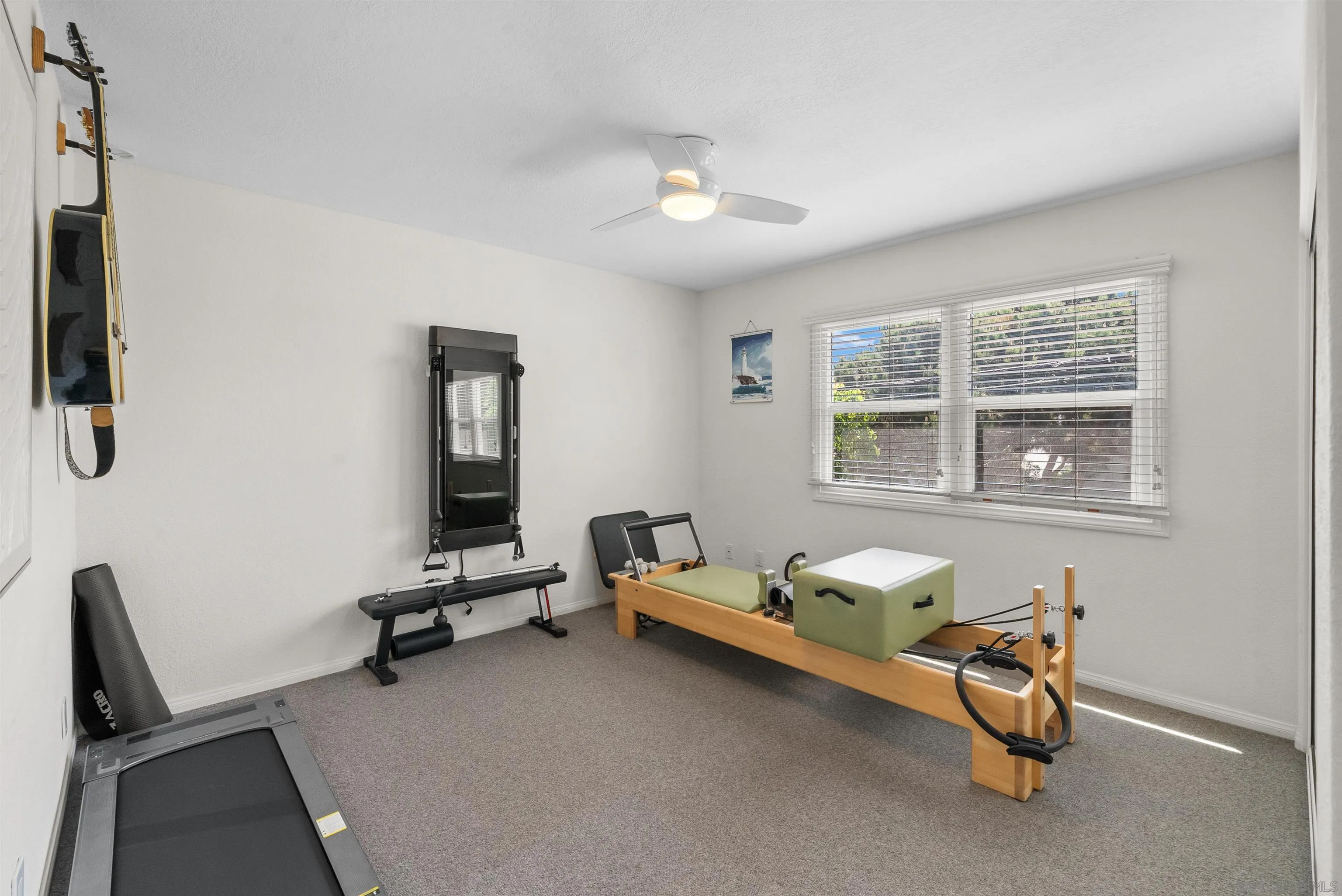 6755 Tyrian Street La Jolla, CA 92037 - Photo 22 of 60 a living room with furniture gym equipment and a window