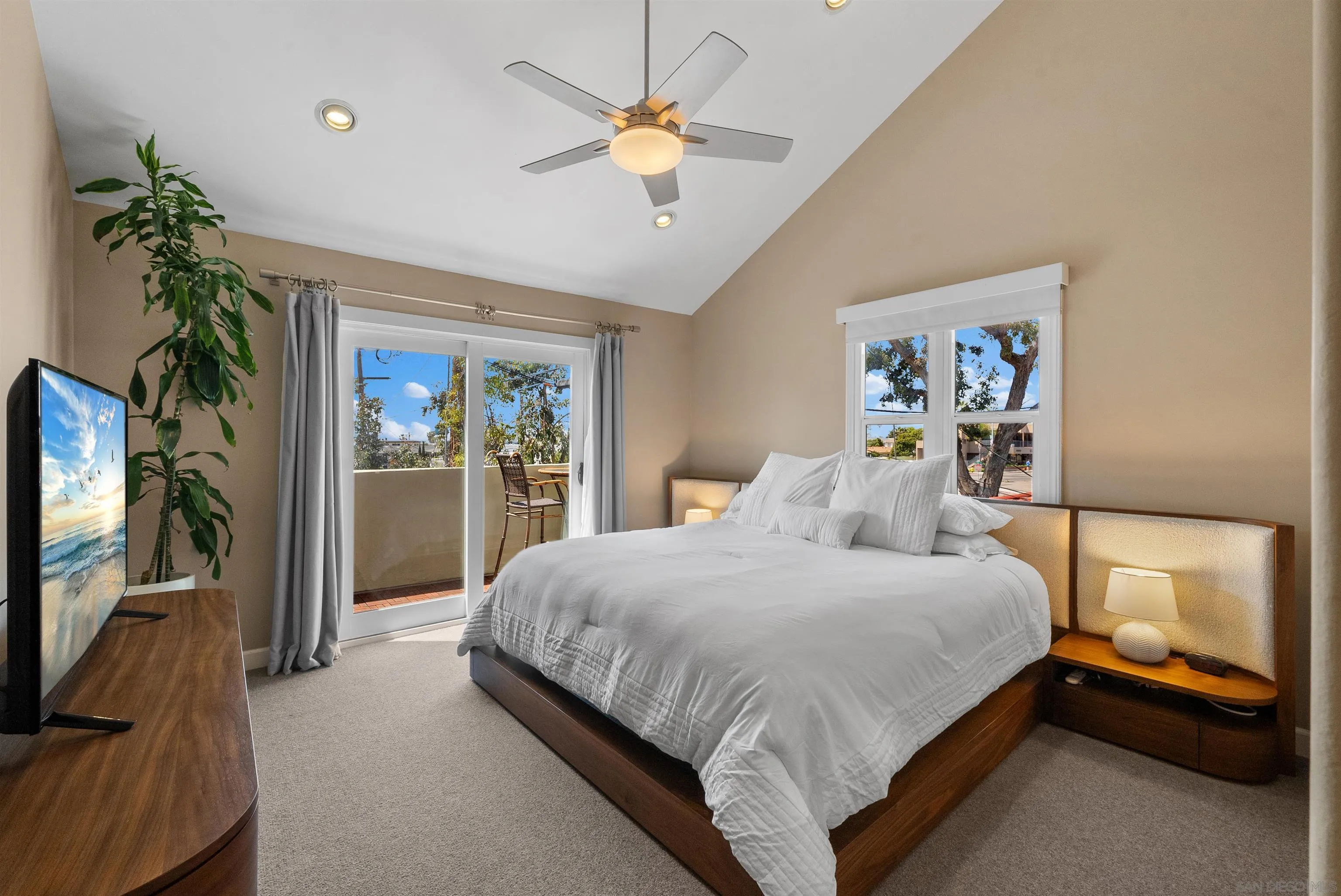 6755 Tyrian Street La Jolla, CA 92037 - Photo 24 of 60 a bedroom with a bed and a flat tv screen on dresser