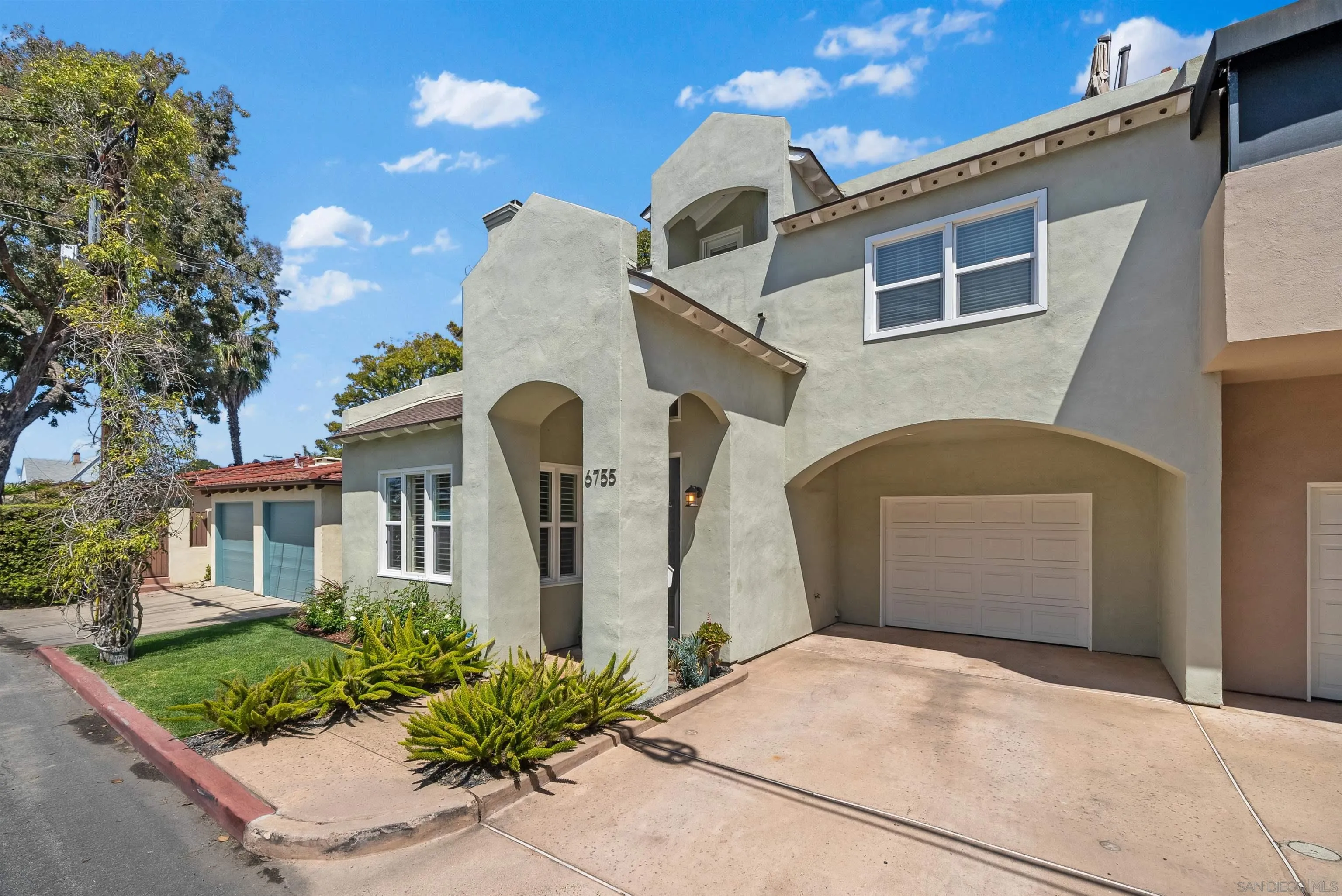 6755 Tyrian Street La Jolla, CA 92037 - Photo 8 of 60 a front view of a house with a yard and garage