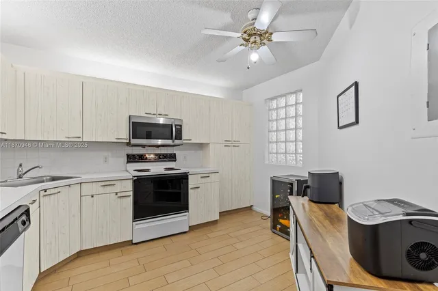 a kitchen with a stove sink and microwave