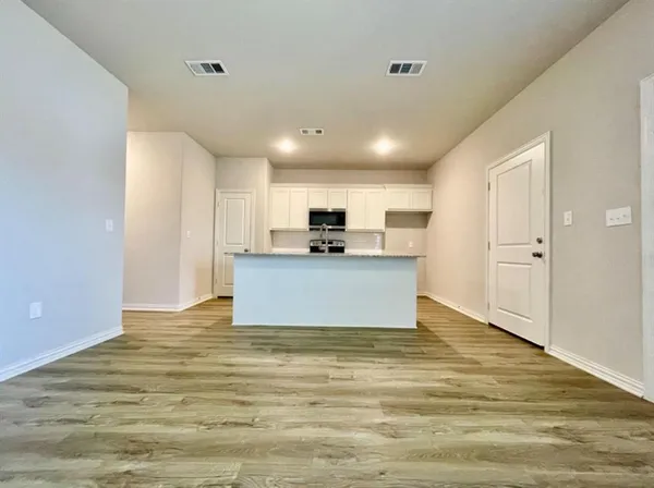 a view of a kitchen with a sink cabinets and wooden floor