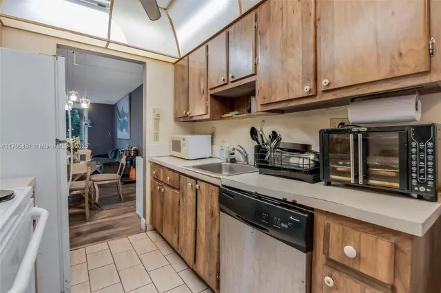 a kitchen with stainless steel appliances granite countertop a stove and cabinets