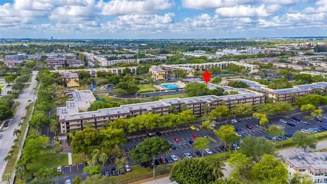an aerial view of residential houses with outdoor space and swimming pool
