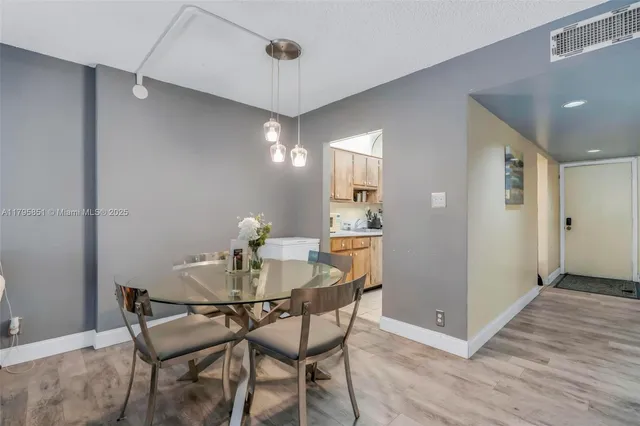 a dining room with furniture and wooden floor