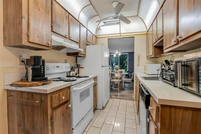a kitchen with stainless steel appliances granite countertop a stove and a sink