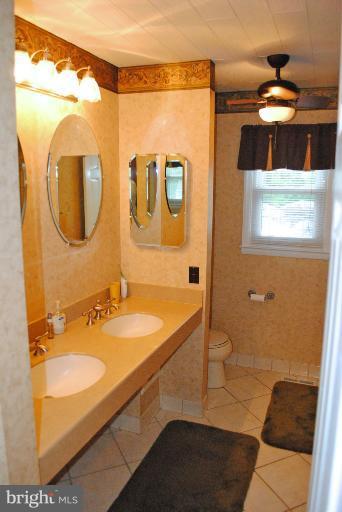 8901 Parlo Road Baltimore, MD 21236 - Photo 14 of 27 a bathroom with a sink and a mirror