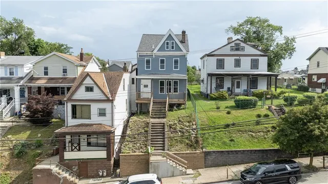 a front view of residential houses with yard