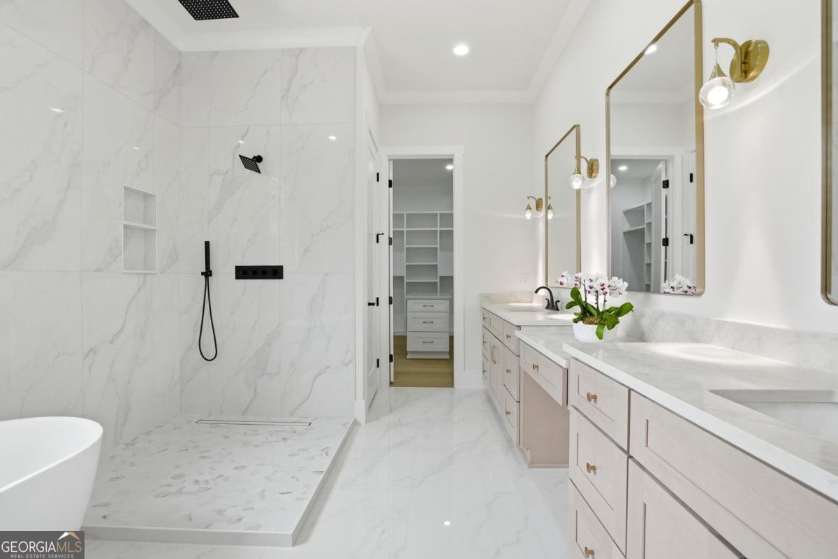 1557 Whitley Road Dacula, GA 30019 - Photo 22 of 46 a bathroom with a shower sink and mirror