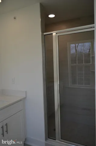 a bathroom with a glass shower door