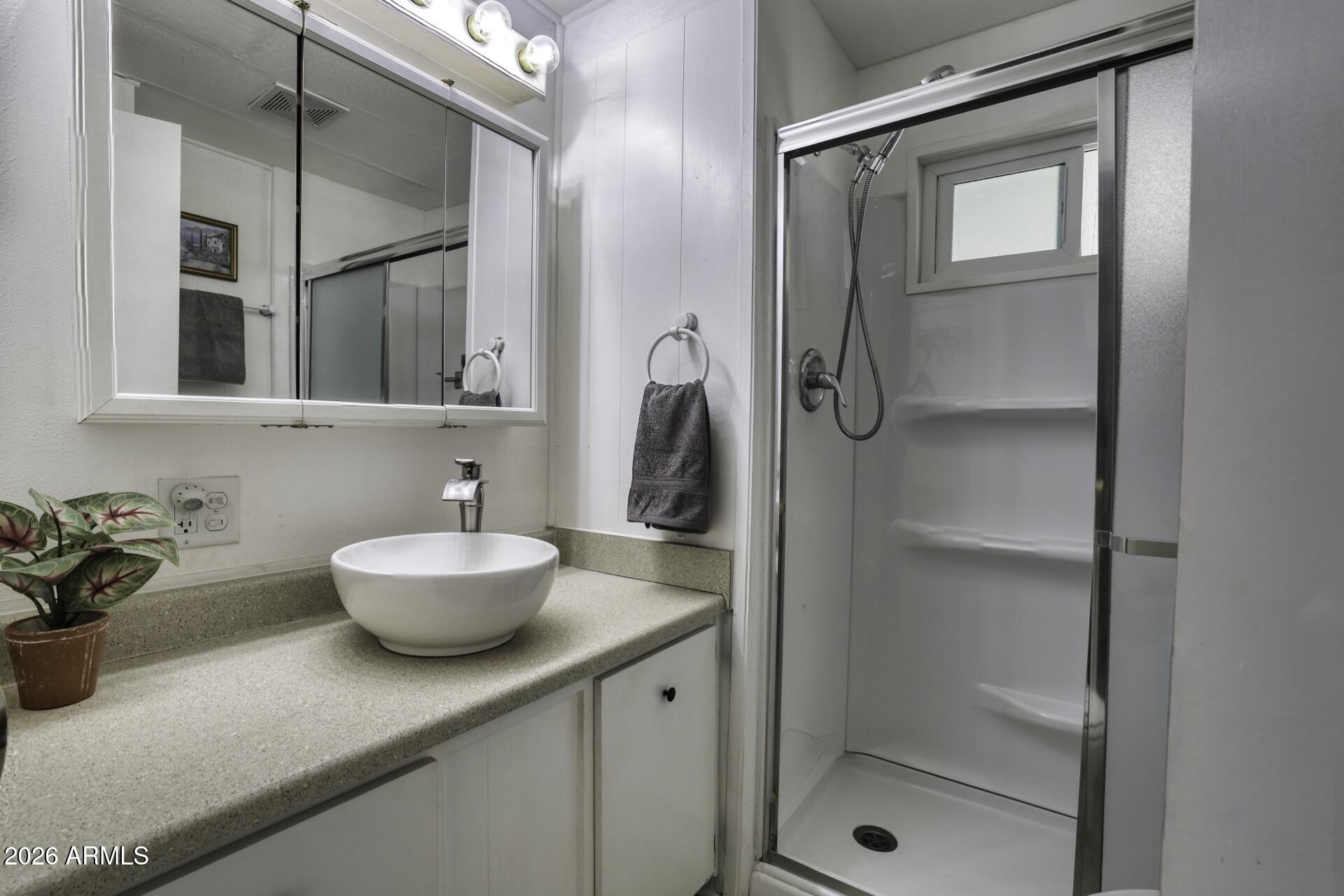 8600 East Broadway Road, Unit 13 Mesa, AZ 85208 - Photo 12 of 16 a bathroom with a sink a toilet and shower