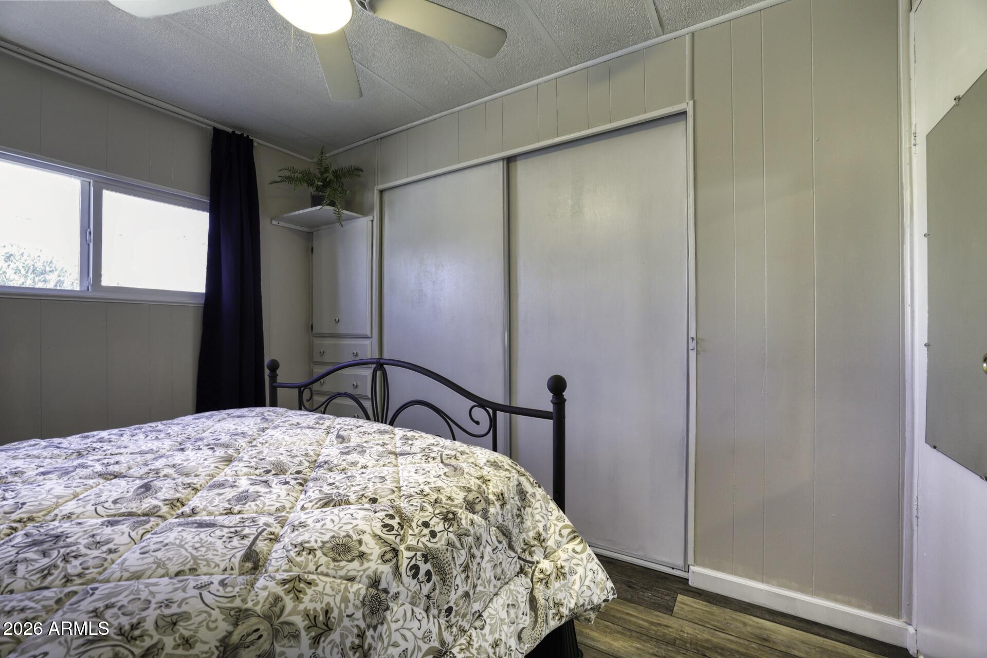 8600 East Broadway Road, Unit 13 Mesa, AZ 85208 - Photo 9 of 16 a bedroom with a large bed and a chandelier