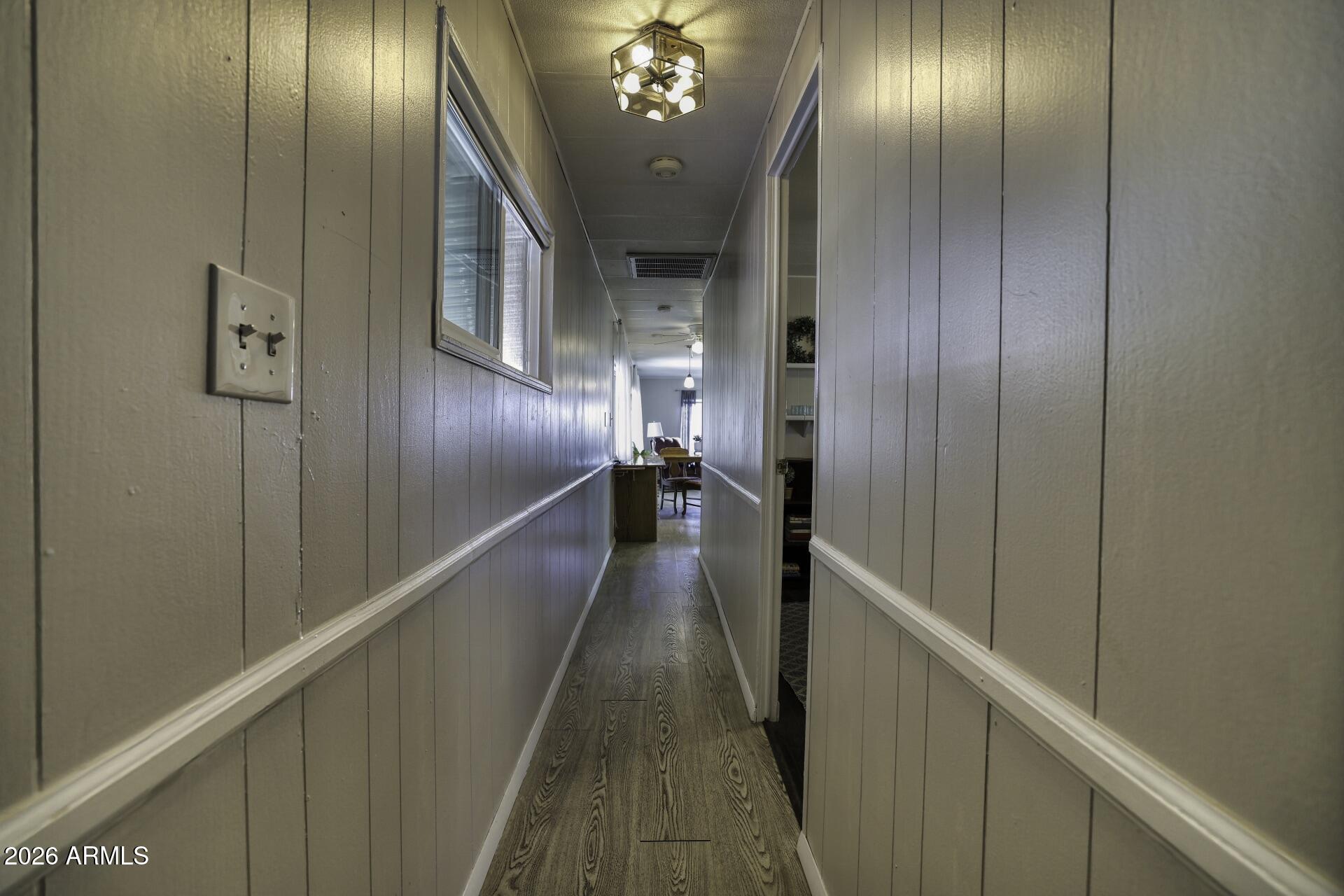 8600 East Broadway Road, Unit 13 Mesa, AZ 85208 - Photo 10 of 16 a view of a hallway with wooden floor