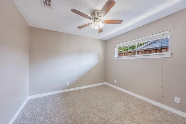 a front view of a house with a yard and potted plants