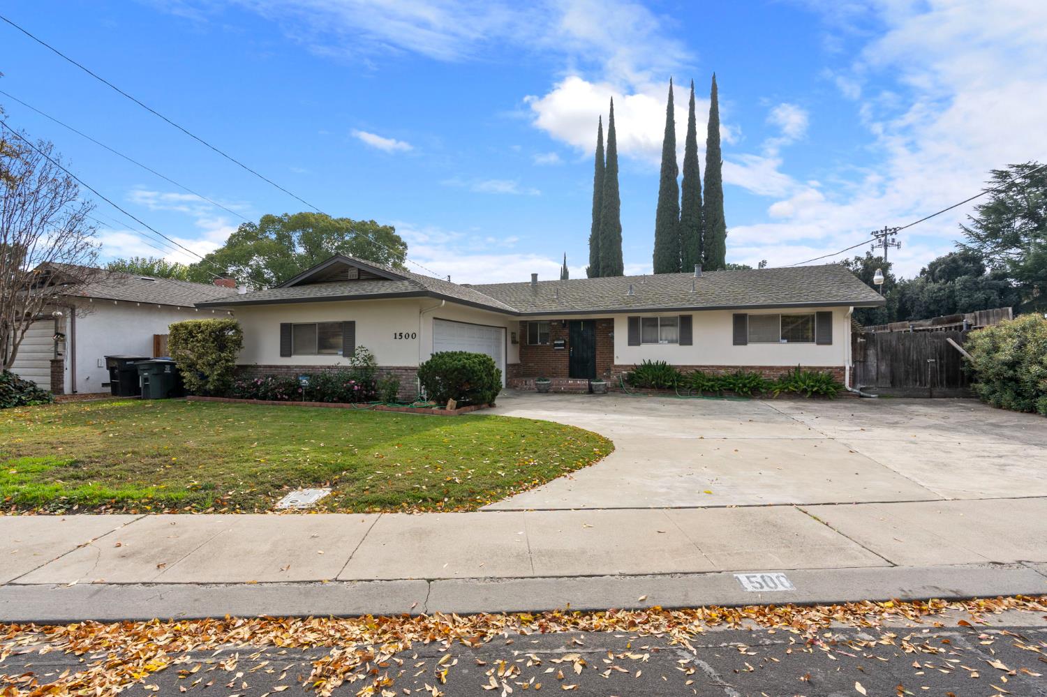 1500 Crestview Drive Modesto, CA 95355 - Photo 1 of 32 a front view of a house with a garden