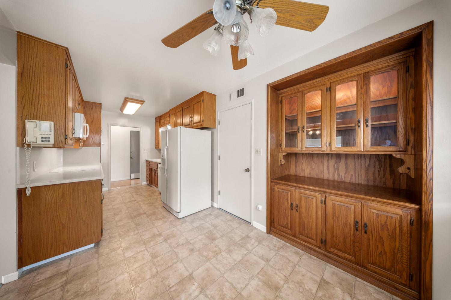 1500 Crestview Drive Modesto, CA 95355 - Photo 11 of 32 a view of a kitchen with an entryway and a refrigerator