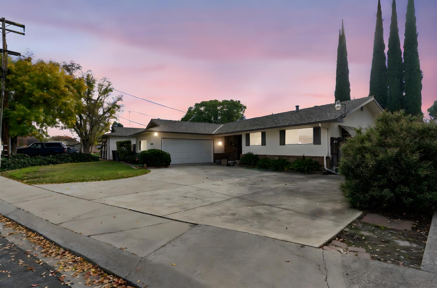 1500 Crestview Drive Modesto, CA 95355 - Photo 4 of 32 a front view of a house with a yard and a garage