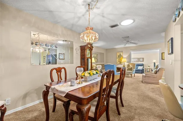 a living room with furniture and a painting on the wall