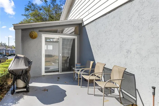 a view of a house with swimming pool and sitting area
