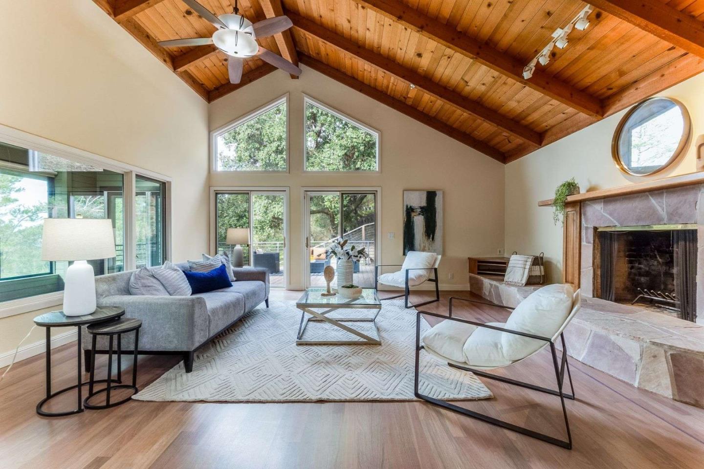22340 Regnart Road Cupertino, CA 95014 - Photo 11 of 74 a living room with furniture a fireplace and a large window