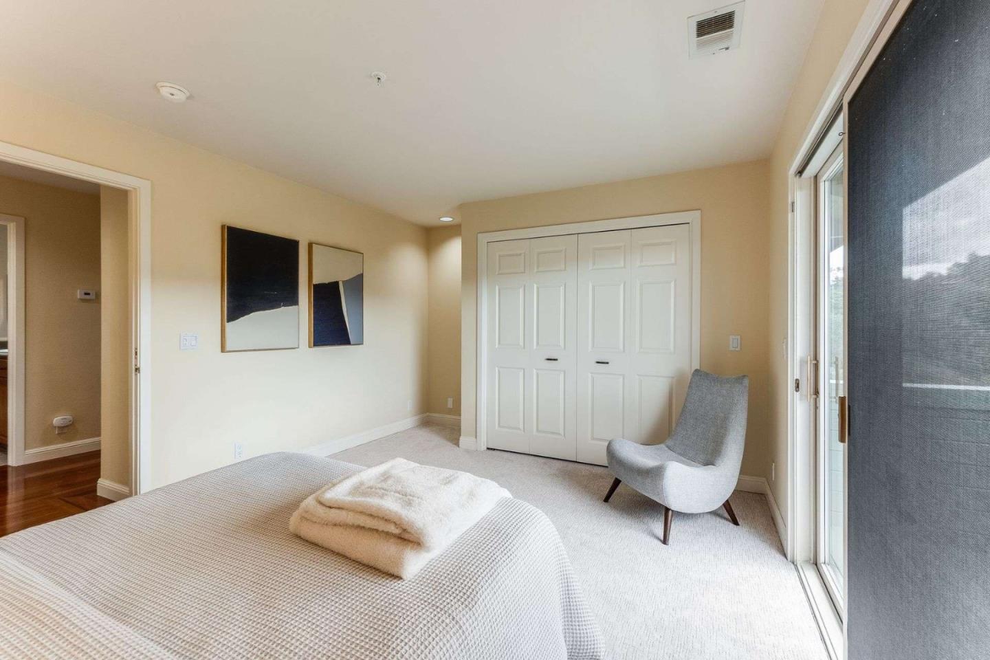 22340 Regnart Road Cupertino, CA 95014 - Photo 17 of 74 a bedroom with a bed and a chair