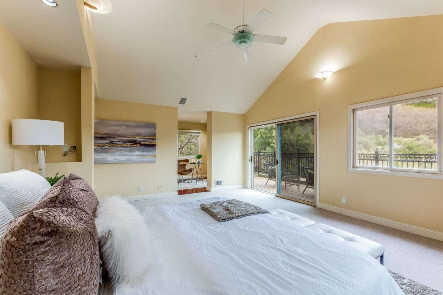 22340 Regnart Road Cupertino, CA 95014 - Photo 21 of 74 a bedroom with a large bed and a large window