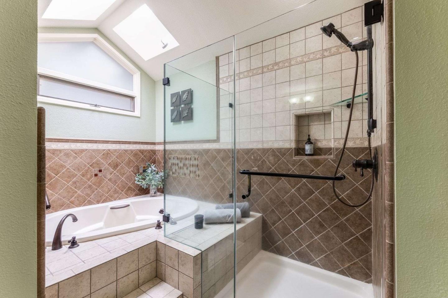 22340 Regnart Road Cupertino, CA 95014 - Photo 26 of 74 a bathroom with a sink a bathtub and a shower