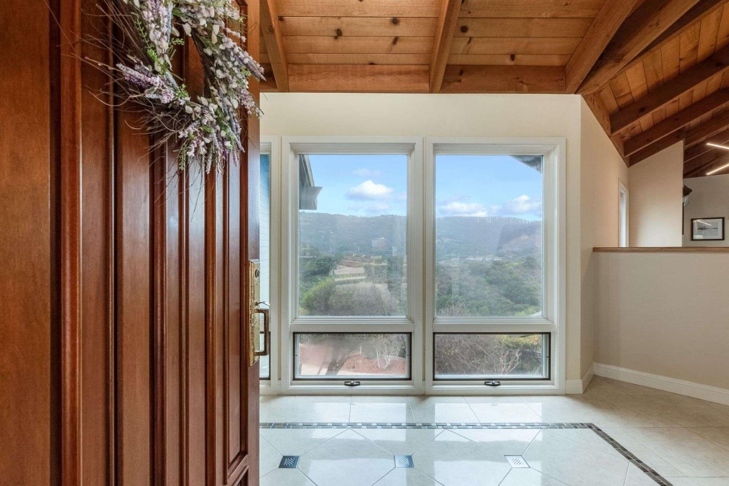 22340 Regnart Road Cupertino, CA 95014 - Photo 3 of 74 a view of a glass door with a glass door