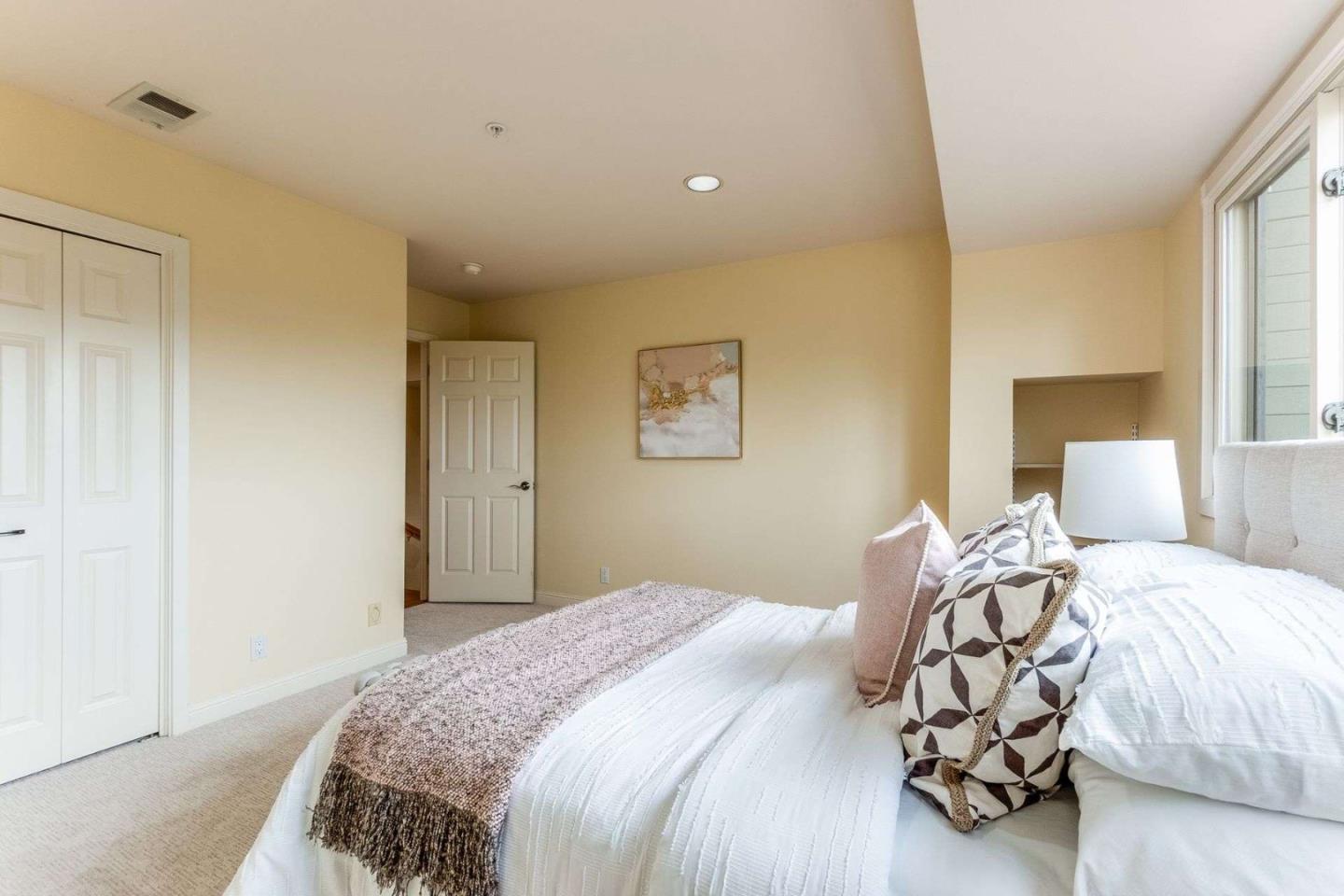 22340 Regnart Road Cupertino, CA 95014 - Photo 31 of 74 a bedroom with a bed and a night stand