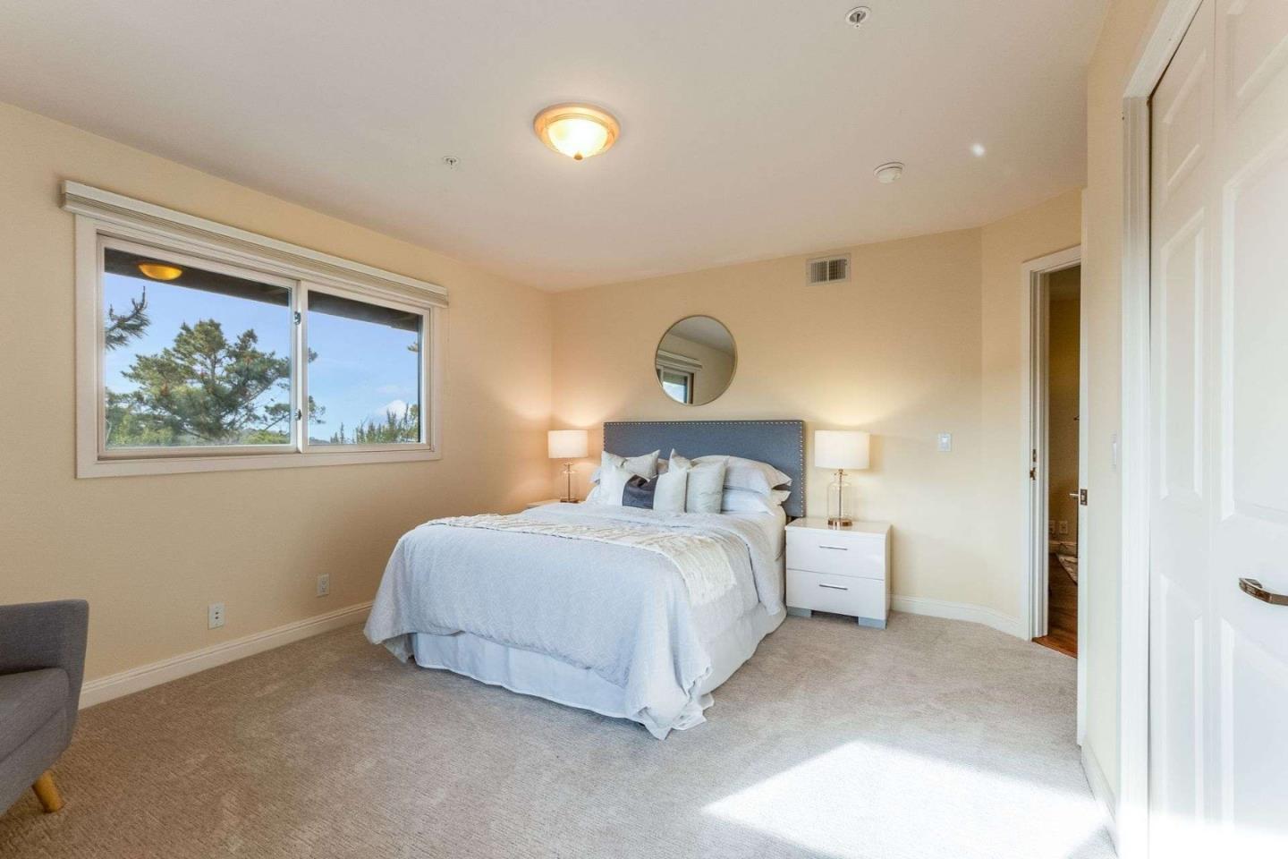 22340 Regnart Road Cupertino, CA 95014 - Photo 33 of 74 a bedroom with a bed and a painting on the wall