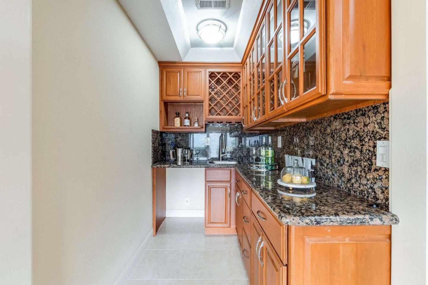 22340 Regnart Road Cupertino, CA 95014 - Photo 40 of 74 a kitchen with stainless steel appliances granite countertop a sink and dishwasher a stove with wooden floor