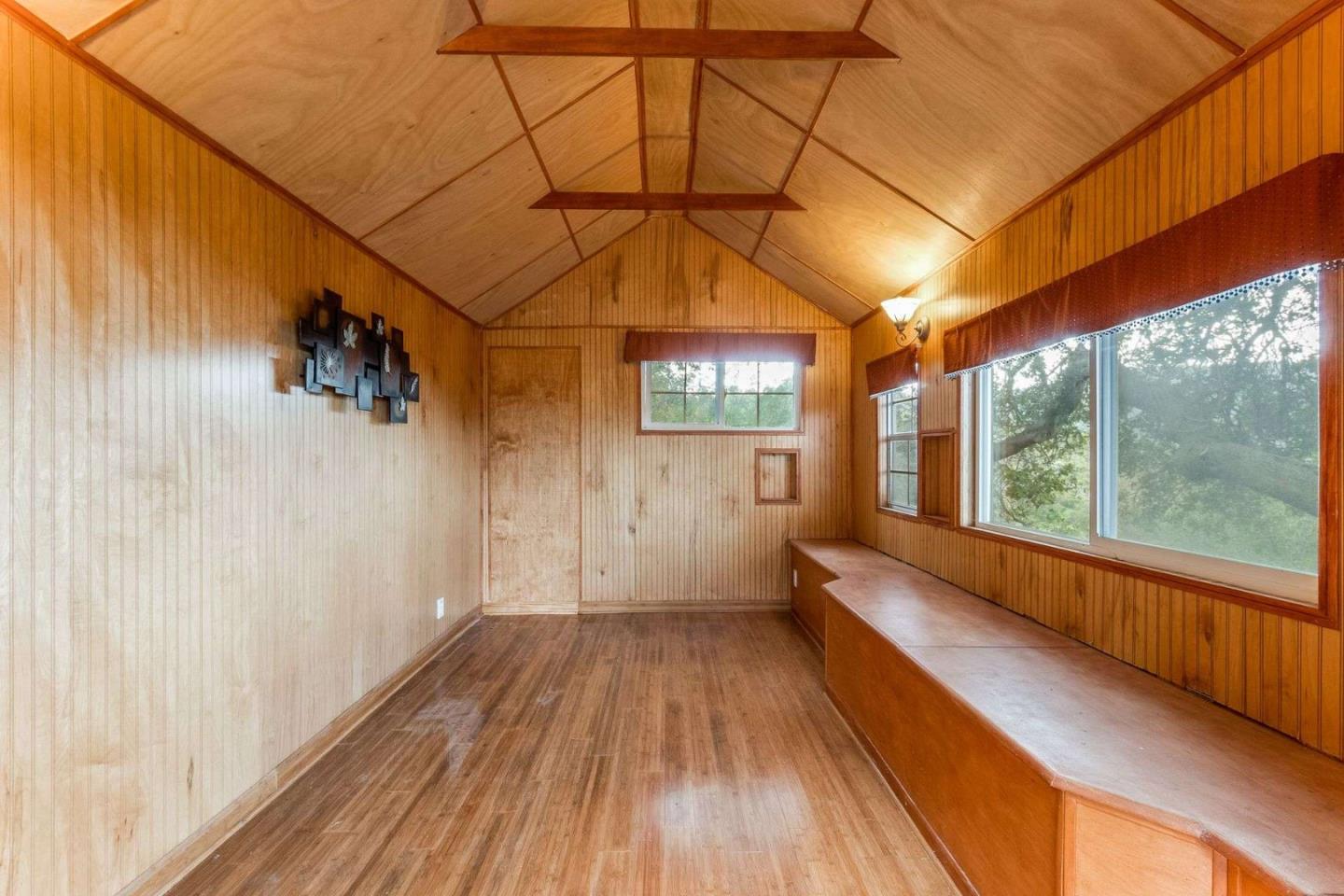 22340 Regnart Road Cupertino, CA 95014 - Photo 51 of 74 a view of a room with wooden floor and iron stairs