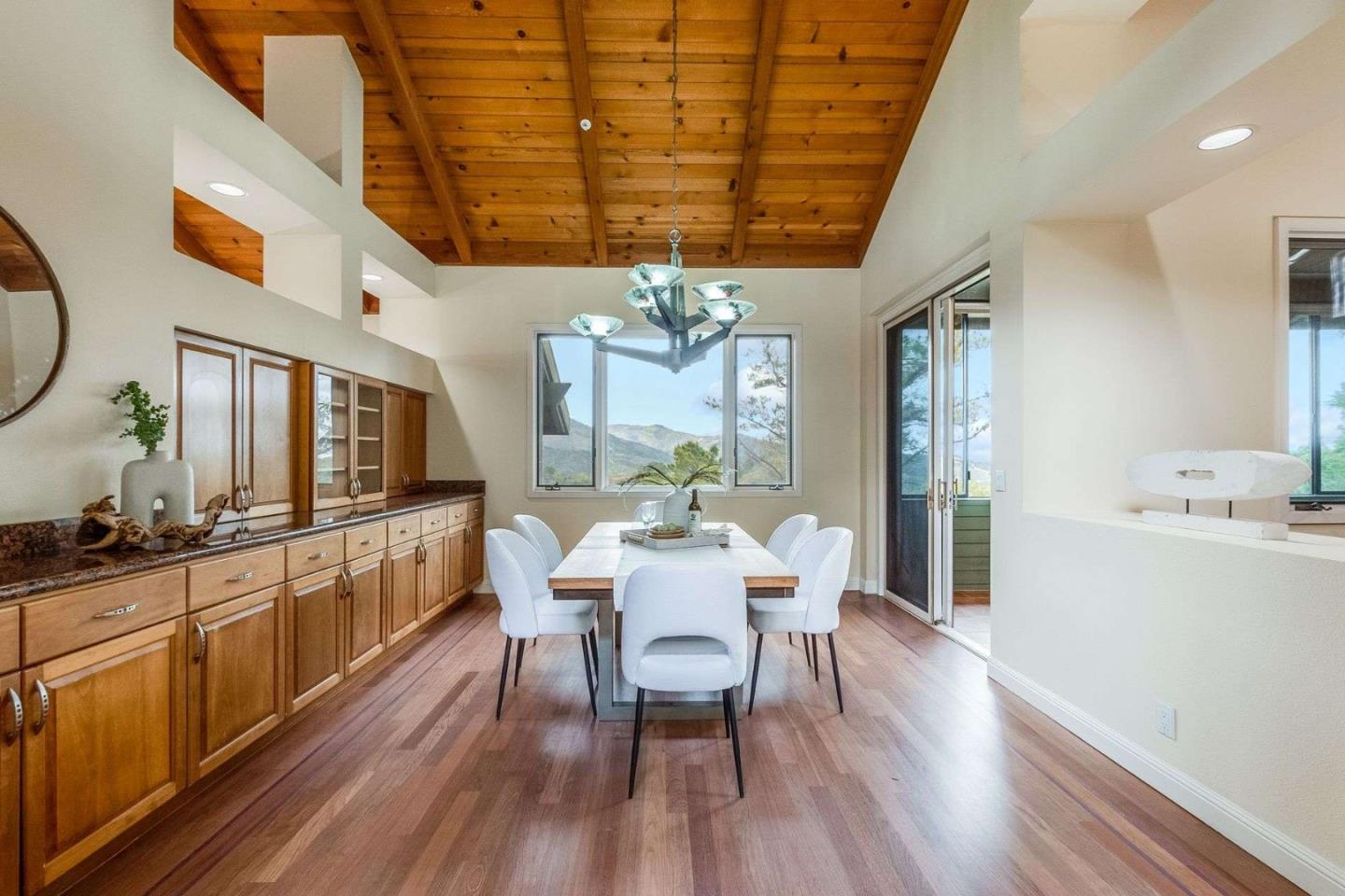 22340 Regnart Road Cupertino, CA 95014 - Photo 8 of 74 a view of a dining room with furniture a chandelier and wooden floor