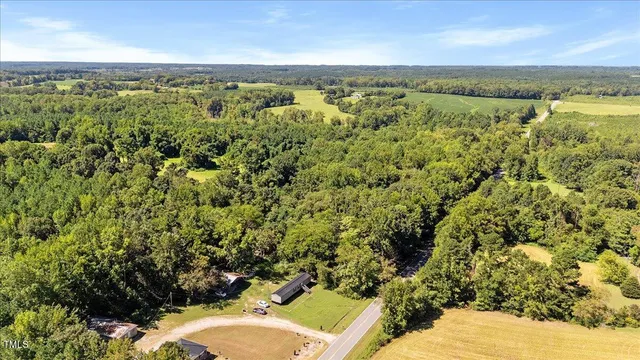 an aerial view of a houses with a yard