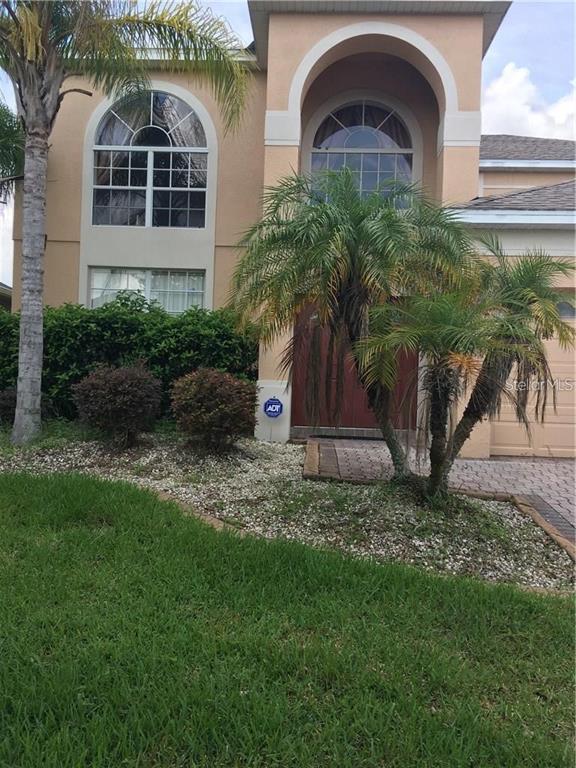 5948 Winchester Isle Road Orlando, FL 32829 - Photo 3 of 23 a front view of a house with garden