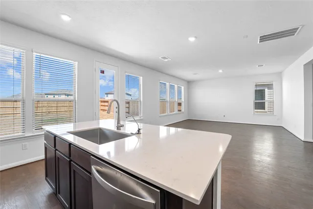 a kitchen with a stove a sink and a refrigerator
