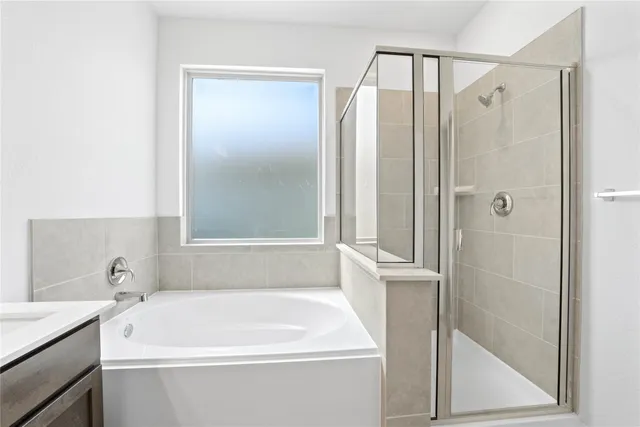 a white bath tub sitting next to a white sink