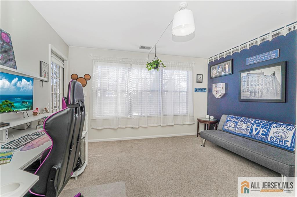 2710 Ridgefield Court Helmetta, NJ 08828 - Photo 3 of 32 a living room with furniture and a flat screen tv