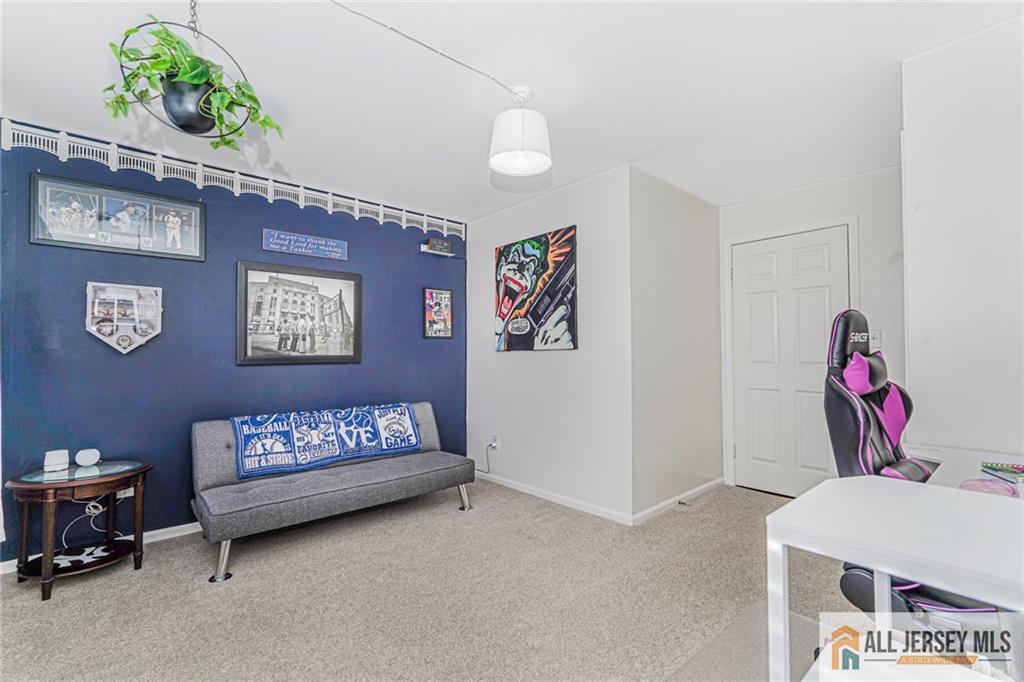 2710 Ridgefield Court Helmetta, NJ 08828 - Photo 5 of 32 a bedroom with a bed and a chandelier