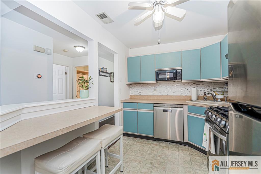 2710 Ridgefield Court Helmetta, NJ 08828 - Photo 8 of 32 a kitchen with stainless steel appliances granite countertop a sink and a stove
