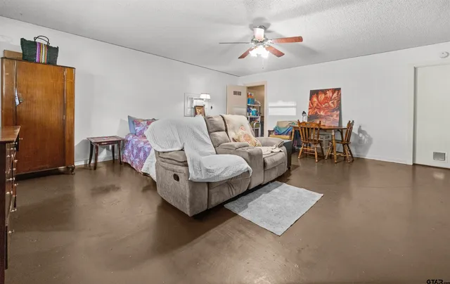 a view of a backyard with a table and chairs a barbeque