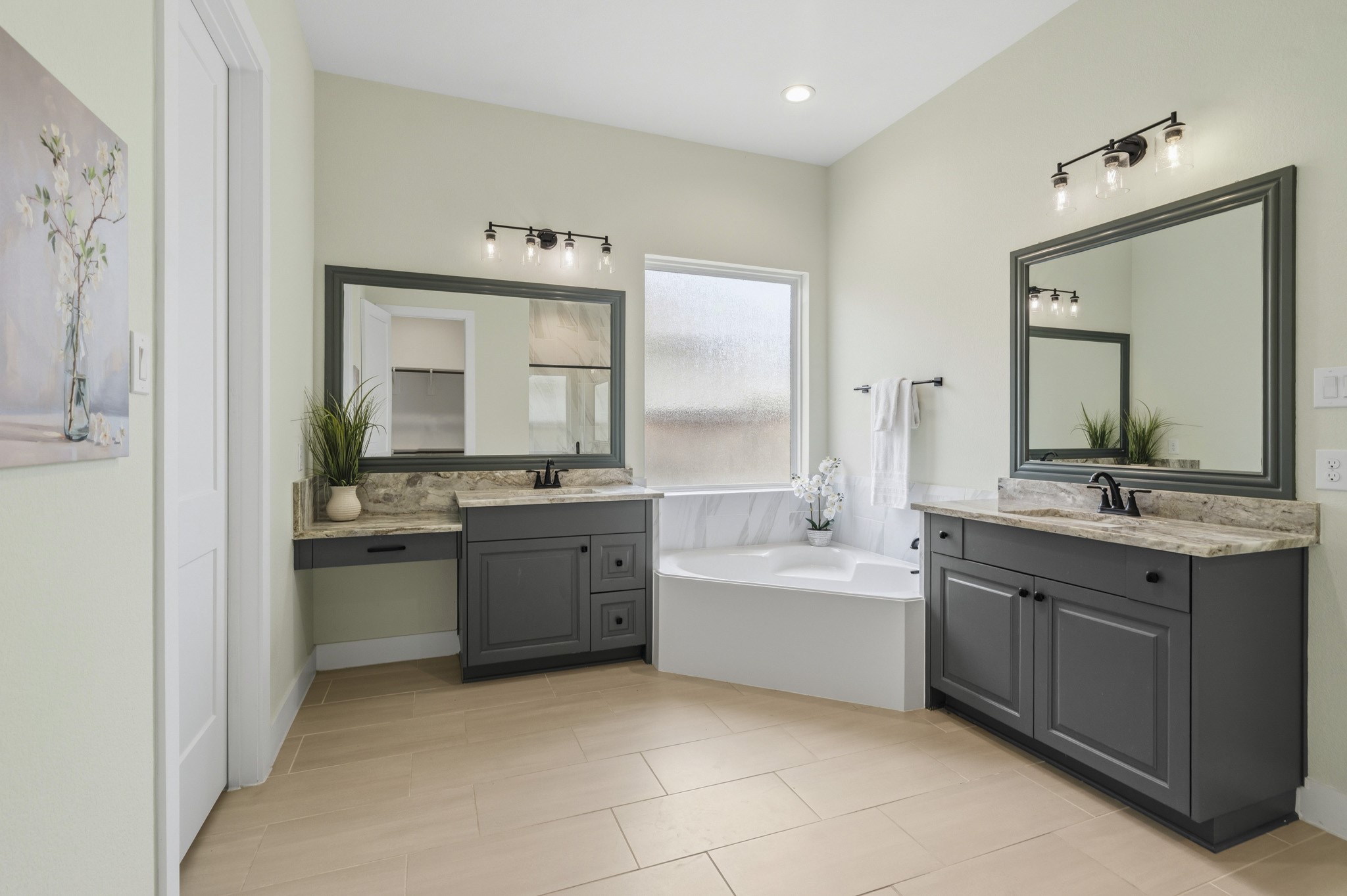 32607 Fly Fish Way Fulshear, TX 77441 - Photo 21 of 41 The Primary Bath exudes sophistication and timeless style, offering a beautifully designed retreat for daily relaxation. Thoughtfully appointed with dual vanities, a dedicated makeup vanity, elegant granite countertops, and framed mirrors, every detail has been carefully curated to blend luxury with functionality. The result is a refined and inviting space that elevates everyday routines into a spa-like experience.