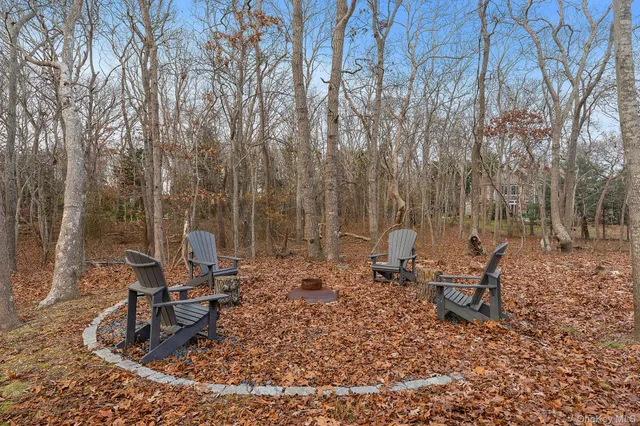 a backyard of a house with table and chairs