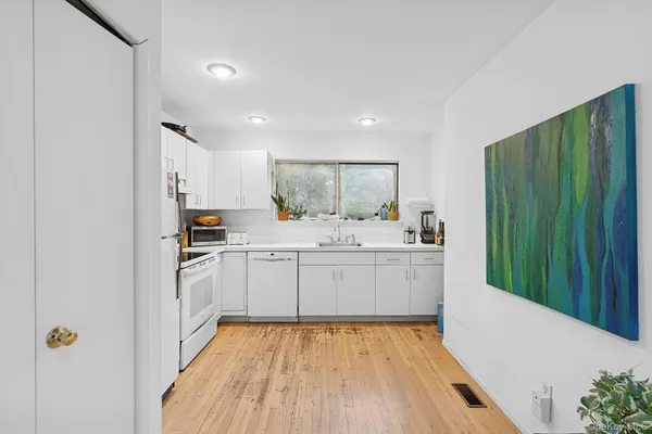 a kitchen with sink refrigerator and cabinets