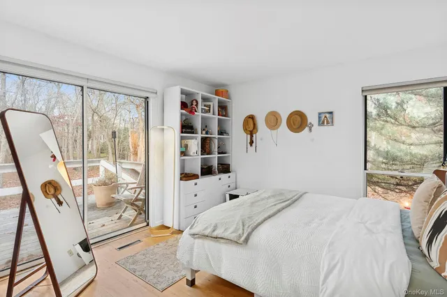 a bedroom with a bed and glass window